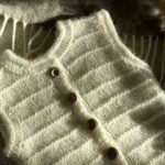 Handgestrickte Baby-Weste aus 100 % Wolle mit Rippenmuster und Holzknöpfen